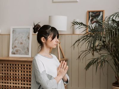 Person meditating in a bright, minimalist space.